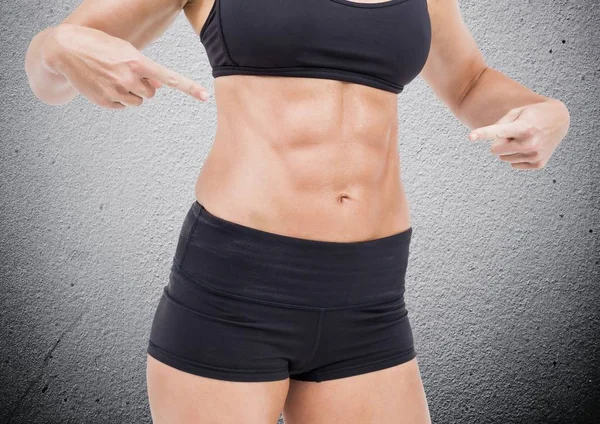 Fit woman pointing her abdomen — Stock Photo, Image