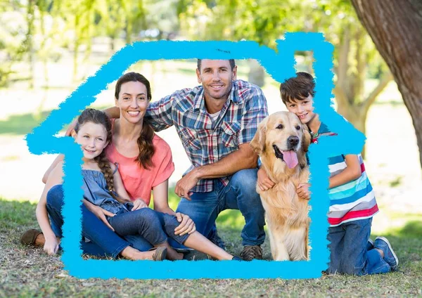 Familj med hund sitter i parken — Stockfoto
