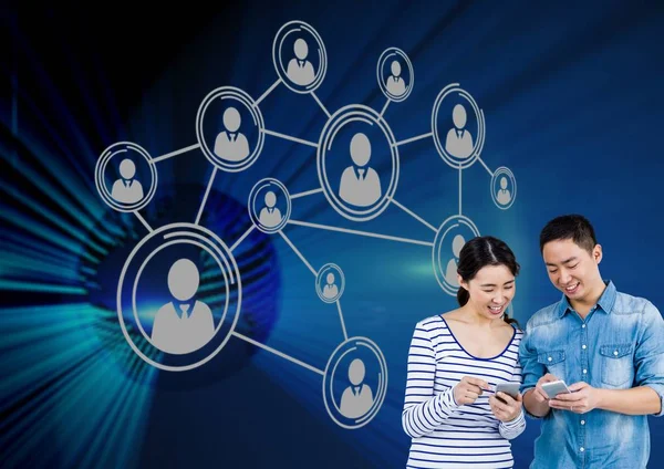 Couple using smartphone with connection icons — Stock Photo, Image