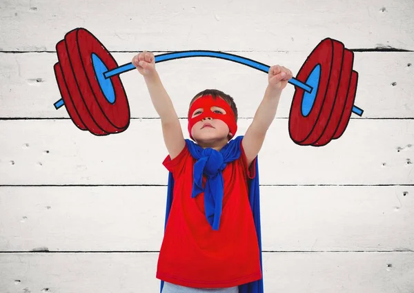 Boy in superhero costume pretending to lift weights against wooden background — Stock Photo, Image