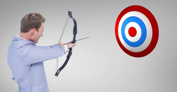 Businessman aiming at the target board — Stock Photo, Image