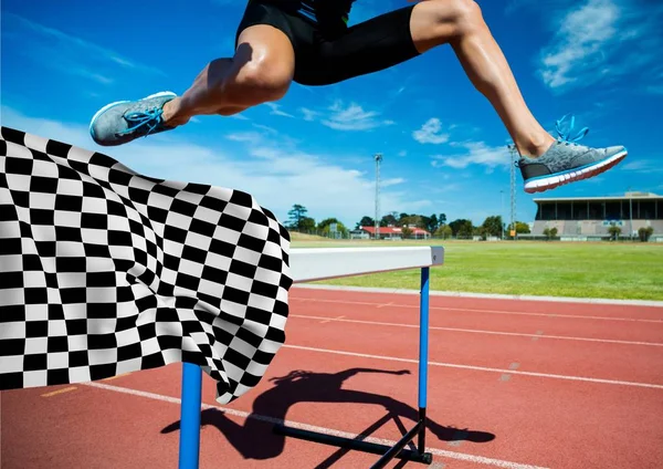 Athlete jumping over hurdles at the finish line — Stock Photo, Image