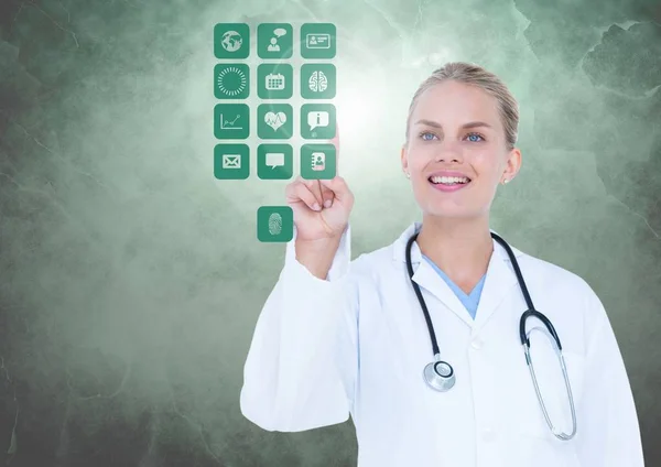 Doctor touching digitally generated medical icons against white background — Stock Photo, Image