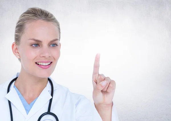 Female doctor pretending to touch an invisible object — Stock Photo, Image