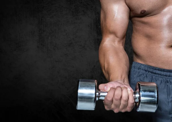 Man performing dumbbell curl exercise against black background — Stock Photo, Image