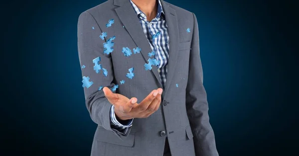 Businessman holding jigsaw puzzle pieces — Stock Photo, Image