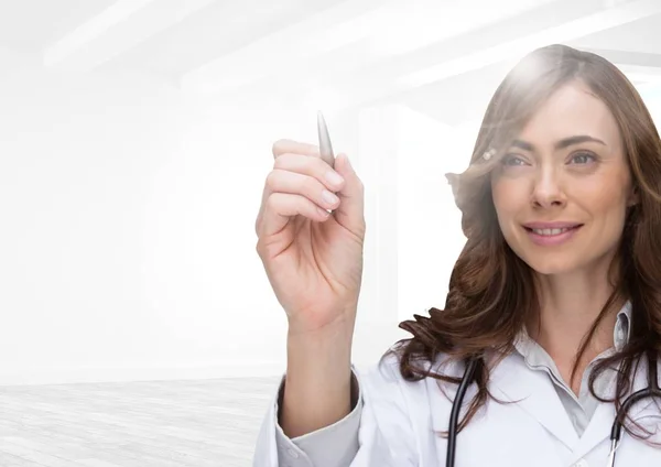 Female doctor pretending to write on invisible screen — Stock Photo, Image