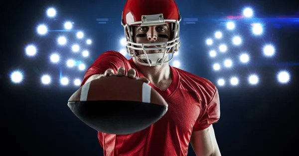 American football player showing ball Stock Photo
