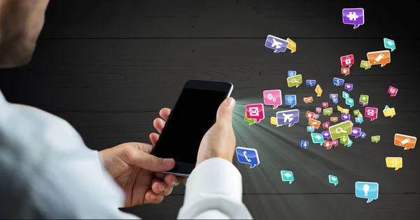 Man holding mobile phone and various application icons in background — Stock Photo, Image