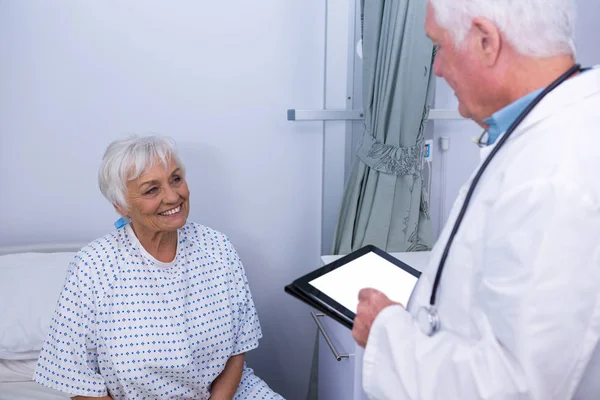 Médico interagindo com paciente idoso na enfermaria — Fotografia de Stock
