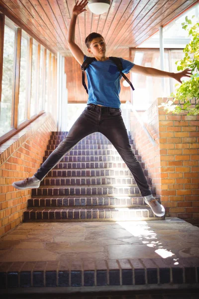 Excited boy jumping near staircase — Stock Photo, Image