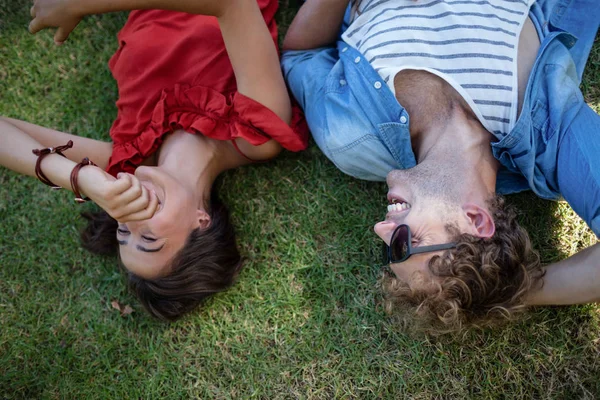 Пара лежит на траве в парке — стоковое фото