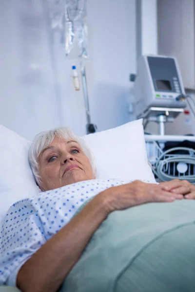 Zmartwiony, starszy pacjenta leżącego na łóżku — Zdjęcie stockowe