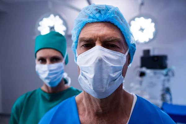 Surgeons wearing surgical mask — Stock Photo, Image