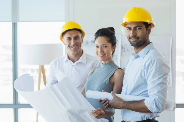 Smiling three architects standing in office — Stock Photo, Image