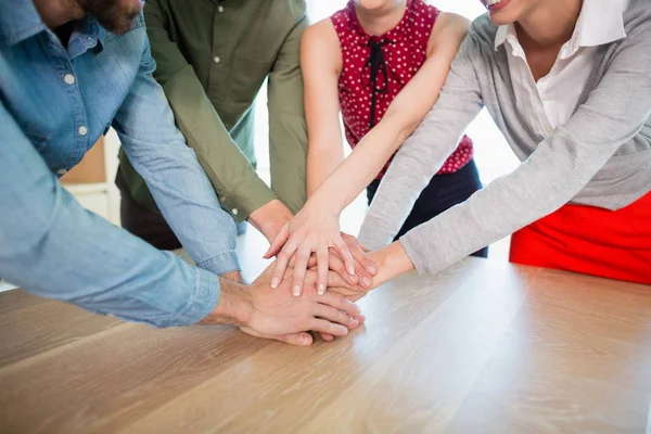 Business executives with their hands stacked — Stock Photo, Image