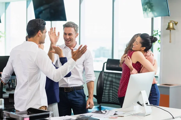 Business colleagues embracing — Stock Photo, Image