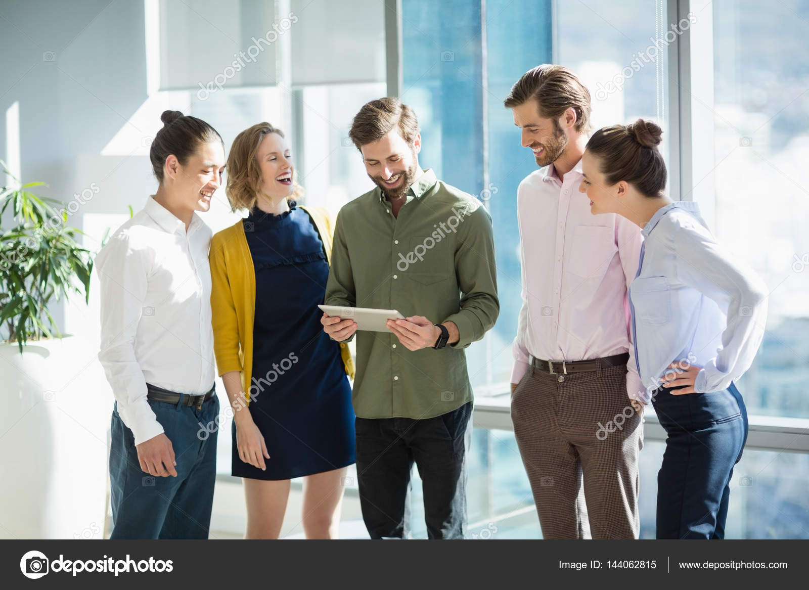 Smiling business executives discussing Stock Photo by ©Wavebreakmedia