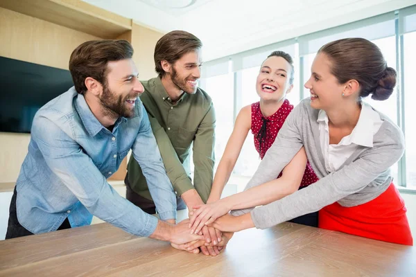 Business executives with their hands stacked — Stock Photo, Image