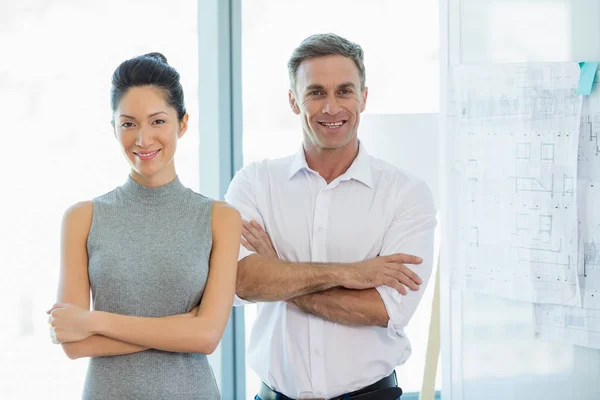 Architects standing with arms crossed in office — Stock Photo, Image