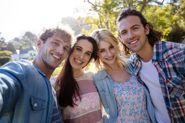 Friends standing together in park — Stock Photo, Image