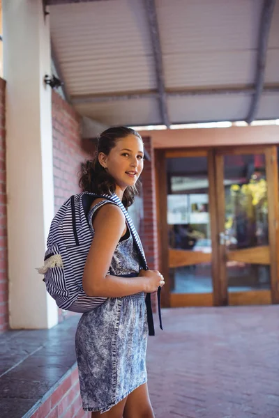 School girl standing with schoolbag — стоковое фото