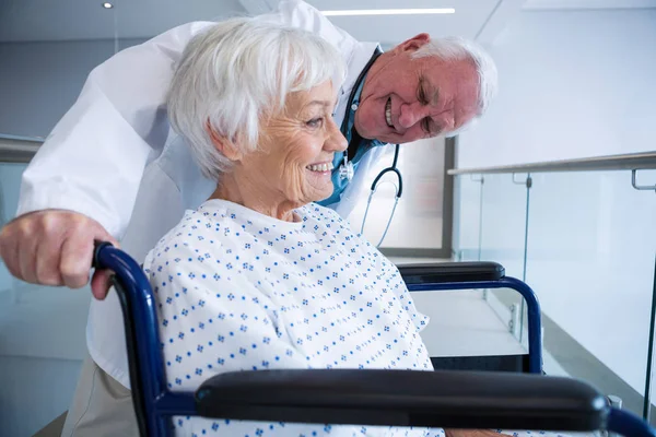 Dokter bedrijf senior patiënt op rolstoel — Stockfoto
