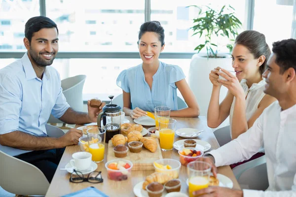 Business colleagues interacting with each other Stock Image