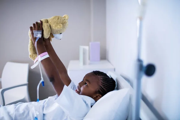 Patient playing with teddy while resting — Stock Photo, Image