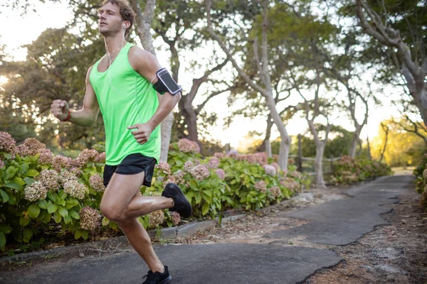 Joggerin joggt auf Gehweg im Park — Stockfoto