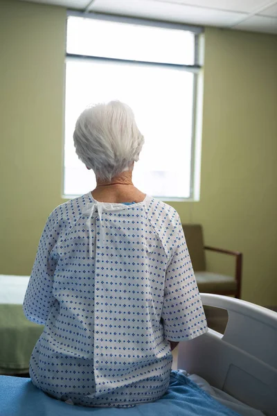 Thoughtful senior patient sitting at hospital — Stock Photo, Image