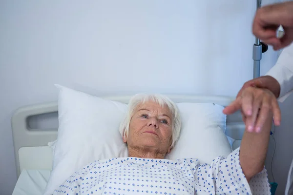 Doctor examining senior patient in ward — Stock Photo, Image