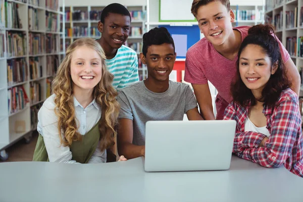 Happy classmates using laptop — Stock Photo, Image