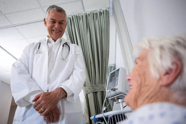 Lekarz interakcji z starszy pacjenta w oddziale — Zdjęcie stockowe