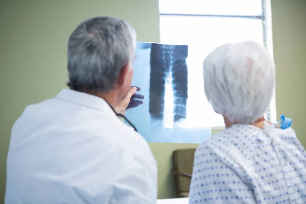 Docteur discutant du rapport de radiographie avec le patient — Photo