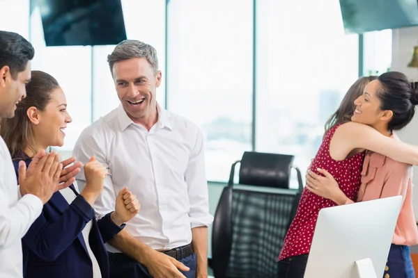 Business colleagues embracing and celebrating — Stock Photo, Image