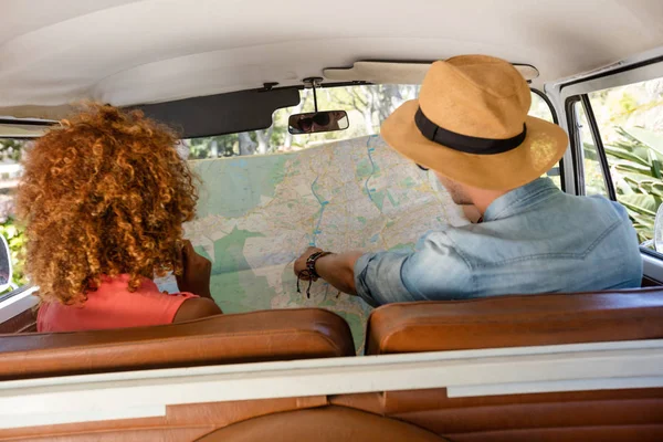 Pareja mirando el mapa en campervan — Foto de Stock