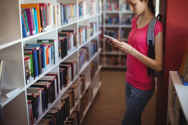 Attentive schoolgirl using digital tablet — Stock Photo, Image