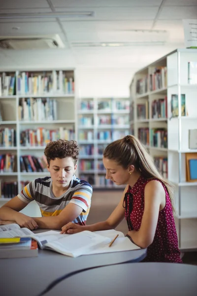 Koledzy, odrabiania lekcji w bibliotece — Zdjęcie stockowe