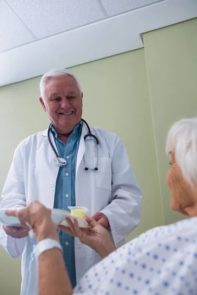 Läkare som serverar frukost och medicin till patienten — Stockfoto