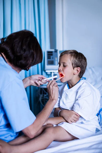 Femmina medico esaminando bocca paziente — Foto Stock