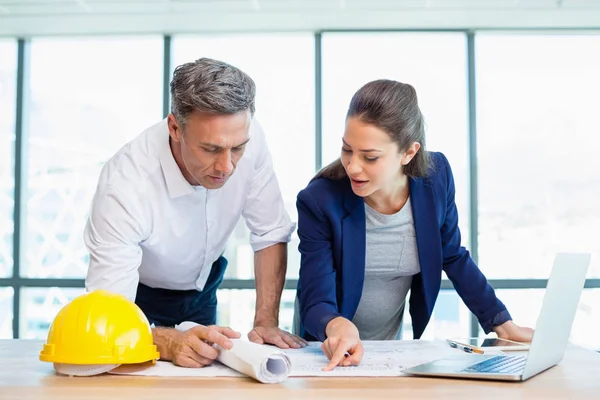 Two architects discussing over blueprint — Stock Photo, Image