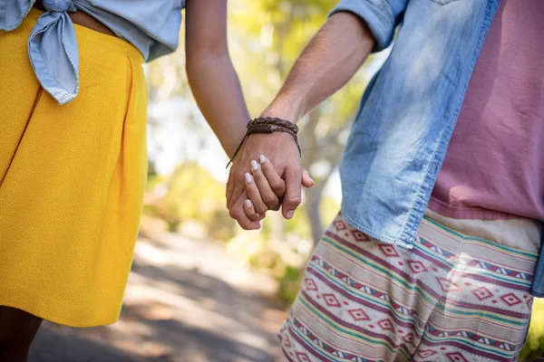 Ett par håller varandra i handen i parken — Stockfoto