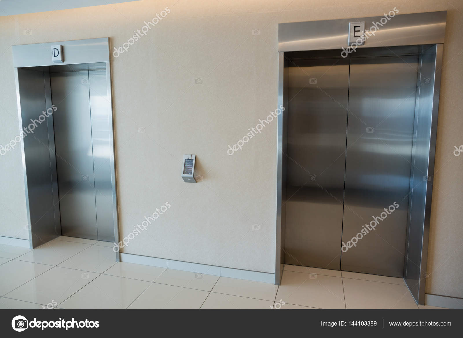 Two elevator doors in lobby of office building — Stock Photo