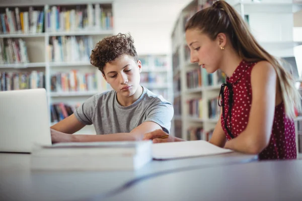 Mitschüler machen Hausaufgaben in Bibliothek — Stockfoto