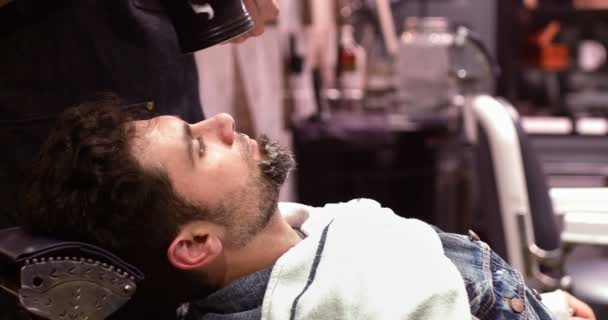 Man getting his beard shaved with shaving brush in barber shop — Stock Video