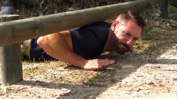 Man crawling under the hurdle — Stock Video