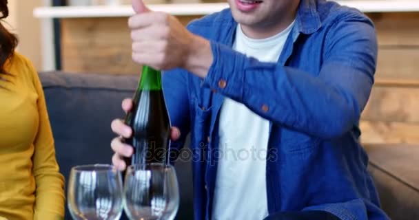 Uomo sorridente versando vino nel bicchiere di vino — Video Stock