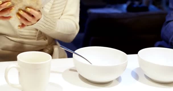 Mid-section of woman pouring cereals in bowl — Stock Video