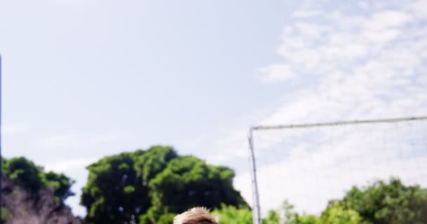 Portrait of happy boy with football lying in park — Stock Video